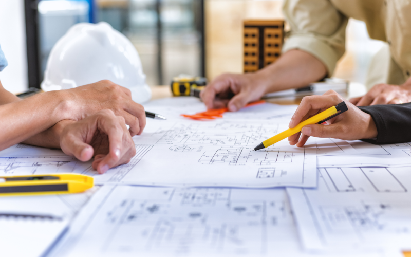 Environmental engineer reviewing remedial design drawings.